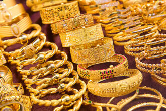 Shiny gold necklaces and rings displayed in Dubai Gold Souk